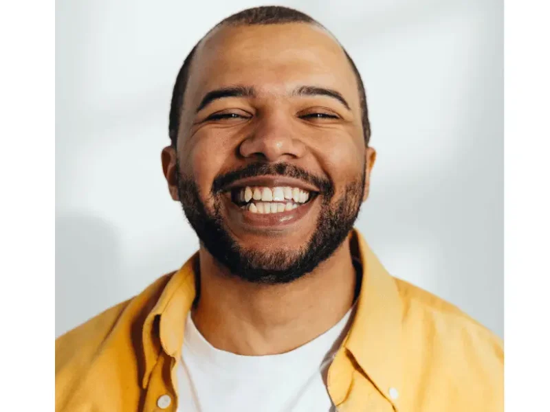 Patient smiling wearing yellow shirt