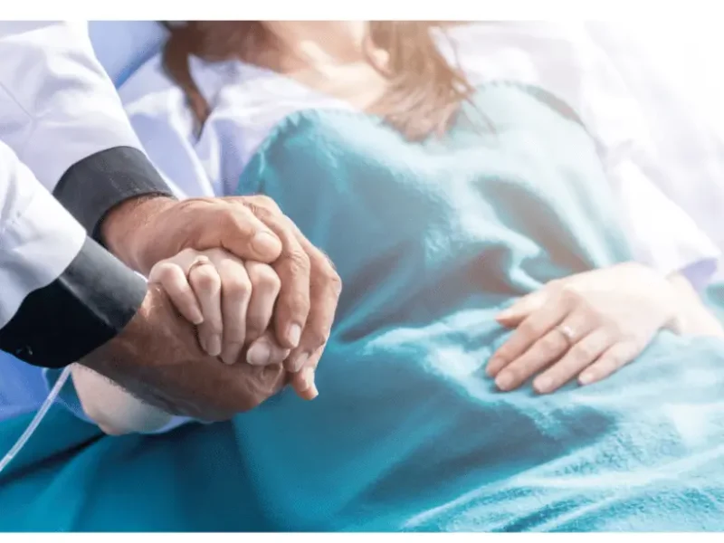 Surgeon comforting patient